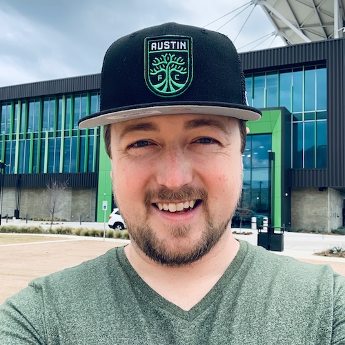 Seth Davis wearing an Austin FC hat in front of the Austin FC soccer stadium